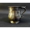 A George V silver half pint tankard of baluster form, with scroll handle, with rubbed maker's marks,... 