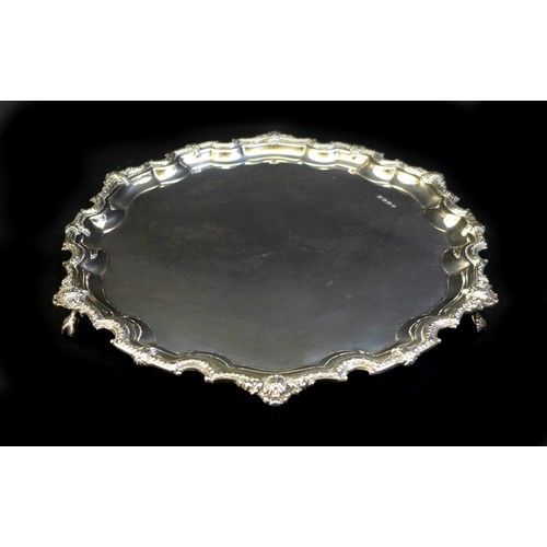 77 - An ERII silver tray, with Chippendale piecrust rim, raise upon four ball and claw feet, Poston Produ... 