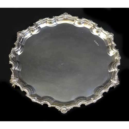 77 - An ERII silver tray, with Chippendale piecrust rim, raise upon four ball and claw feet, Poston Produ... 