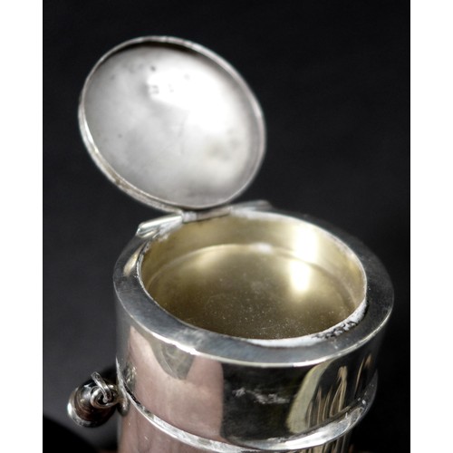23 - An Edwardian silver travelling communion set, the cylindrical body split into two compartments, the ... 