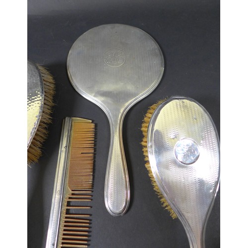 70 - A large collection of silver backed dressing table accessories, including a pair of planished silver... 