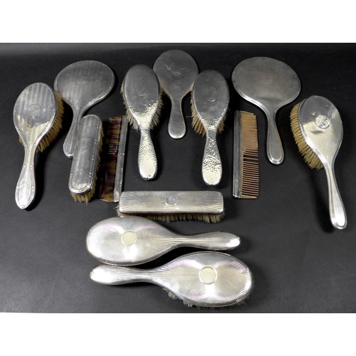 70 - A large collection of silver backed dressing table accessories, including a pair of planished silver... 