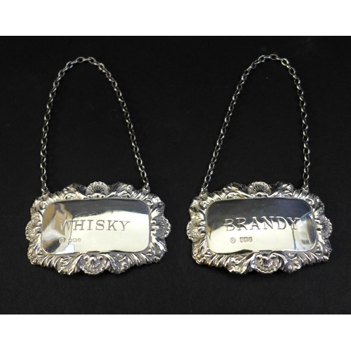 14 - A group of silver items, comprising a pair of spirit decanter labels for Whisky and Brandy, Francis ... 