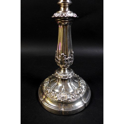 52 - A pair of 19th century Continental white metal candlesticks, the knopped reeded columns clasped with... 