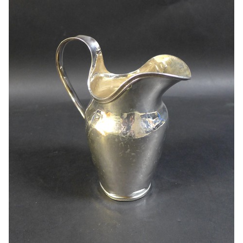 19 - An early 19th century German silver jug, with wide lip, loop handle, and slender decorative borders,... 