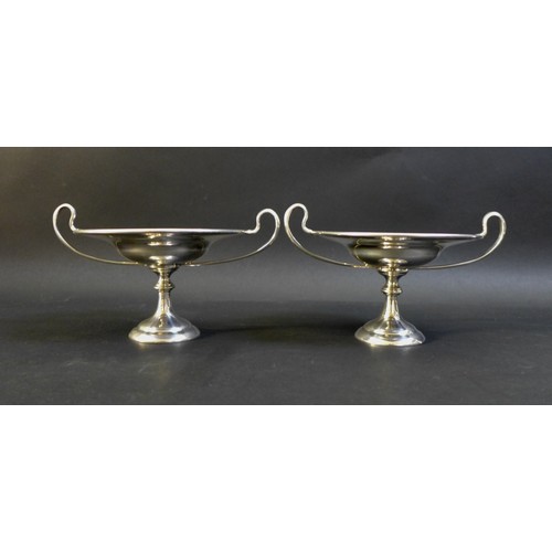 37 - A pair of George V twin handled silver bon bon dishes, raised upon circular stepped bases, both engr... 