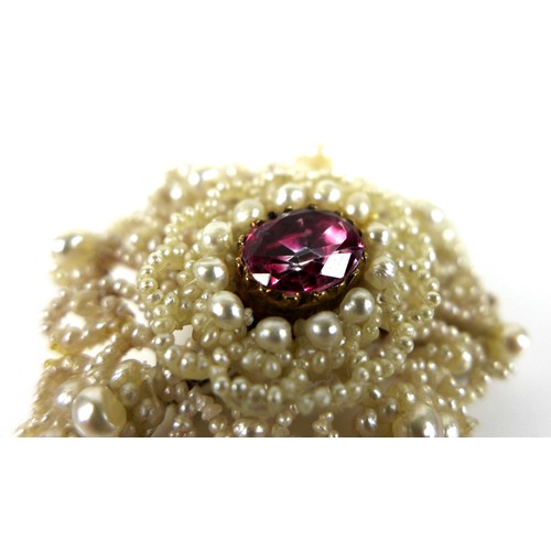 229 - A ruby, mother of pearl and seed pearl brooch, the central oval cut ruby of vibrant rose pink colour... 