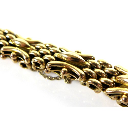 247 - A 15ct gold fancy link bracelet, with safety chain, together with a spare link, 27.1g total.