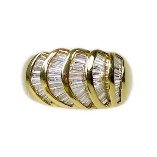 243 - An 18ct gold and diamond ring, of modernist design, set with forty five taper cut diamonds in five g... 