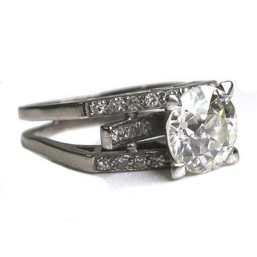 255 - An 18ct white gold and diamond solitaire ring, of modernist design, the brilliant cut stone approxim... 