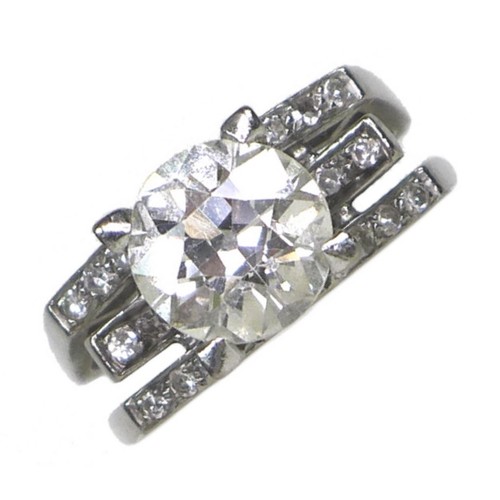 255 - An 18ct white gold and diamond solitaire ring, of modernist design, the brilliant cut stone approxim... 