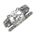 An 18ct white gold and diamond solitaire ring, of modernist design, the brilliant cut stone approxim... 