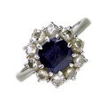 An 18ct white gold, platinum, sapphire and diamond ring, the royal blue cushion cut sapphire 6.9mm b... 