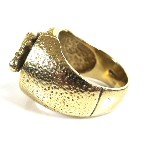 237 - A 9ct gold ring of large textured form, the central motif of a horse within a horseshoe, size Z, 29.... 