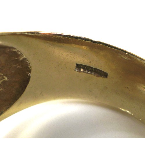 237 - A 9ct gold ring of large textured form, the central motif of a horse within a horseshoe, size Z, 29.... 