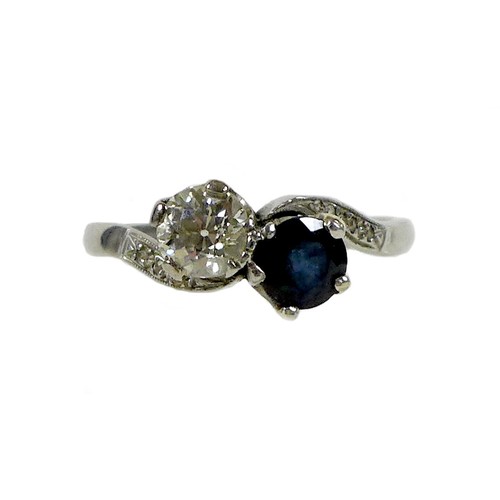 248 - An 18ct gold, platinum, diamond and sapphire 'Moi et Toi' crossover ring, the brilliant cut diamond,... 