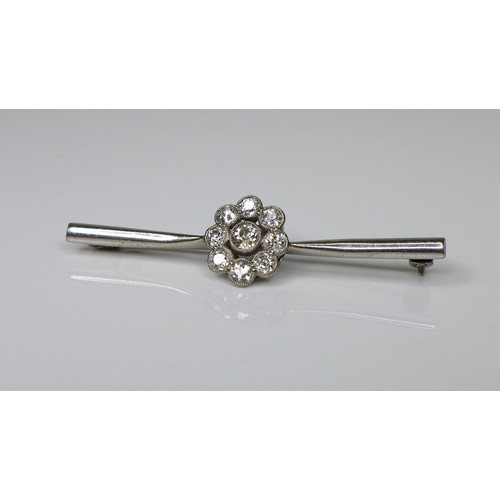 246 - An 18ct white gold and diamond brooch, the central setting of flowerhead form, 12.5mm diameter, on a... 