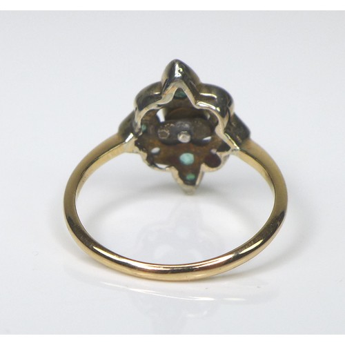 217 - An 18ct gold, emerald and white stone dress ring, the quatrefoil setting with seven emeralds, the ce... 