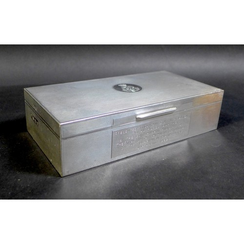 31 - An Elizabeth II silver military presentation cigarette box, of rectangular form with all over engine... 