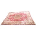 A Persian carpet, with red ground, decorated in green and cream with a large central medallion surro... 