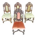 A set of four 17th century oak dining chairs, with barley twist support and carved frame, upholstere... 