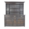 A 17th century oak dresser base, with three frieze drawers over two cupboards with wrought iron hing... 