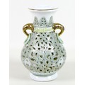A modern Chinese porcelain reticulated vase, of baluster form with gilt highlighted elephant head an... 