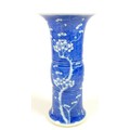 A Chinese porcelain 'Gu' shaped vase, early 20th century, decorated in underglaze blue with prunus b... 