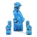A modern Chinese turquoise glazed figure of a Buddhistic lion dog, modelled seated with left forepaw... 