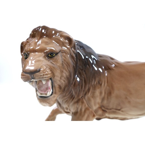 4 - A Beswick Lion - standing, model 2554B, golden brown gloss, 17cm high.