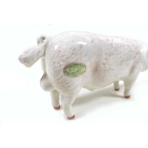 20 - A group of two pig figurines, comprising a Royal Doulton 'Vietnamese Pot-Bellied Piglet', model G213... 