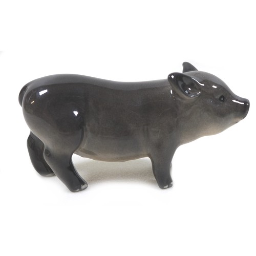 20 - A group of two pig figurines, comprising a Royal Doulton 'Vietnamese Pot-Bellied Piglet', model G213... 