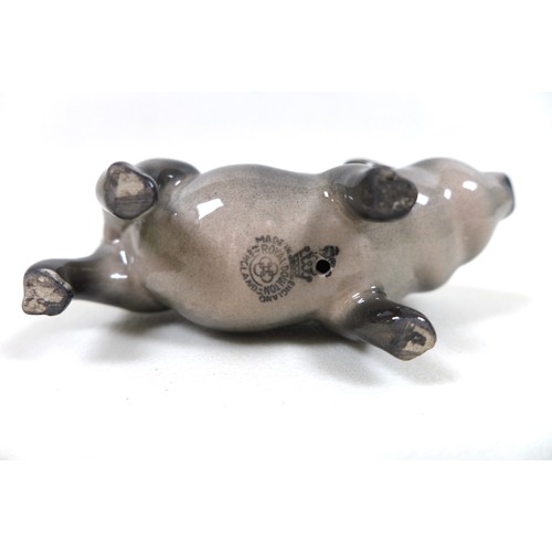 20 - A group of two pig figurines, comprising a Royal Doulton 'Vietnamese Pot-Bellied Piglet', model G213... 