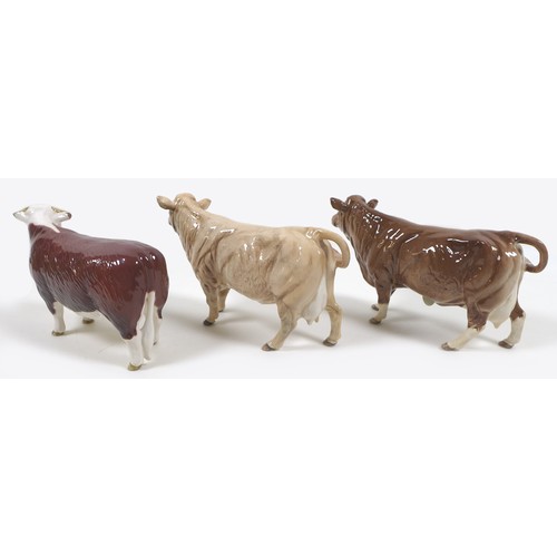 32 - A group of three Beswick cows, comprising a 'Hereford Cow 