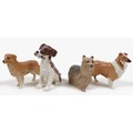 A group of four Beswick dogs, including 'Gnawing', model 2947, white and tan - gloss, 10.8cm high, '... 