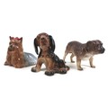 A group of three dog figurines, comprising a Beswick 'Yorkshire Terrier - Lying', model 1944, grey a... 