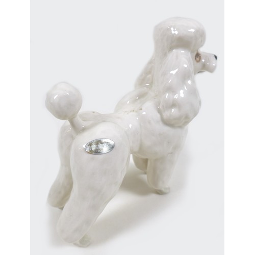 70 - A Beswick 'Poodle', model 2339, white - gloss, 14.6cm high, together with a 'Cocker Spaniel 