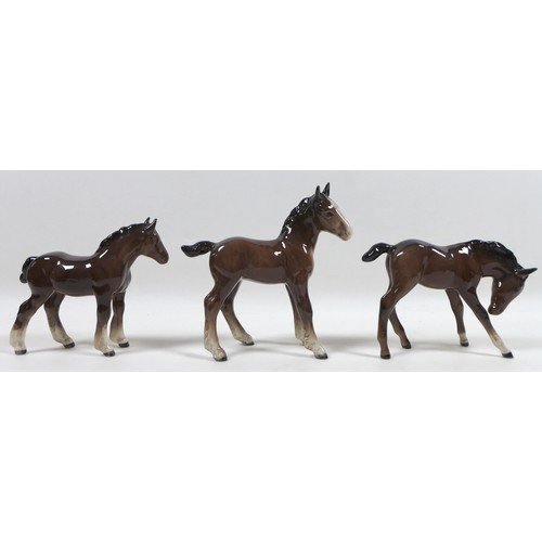 88 - A group of four Beswick foal figurines, including 'Shire Foal (Small)', model 1053, brown - gloss, 1... 