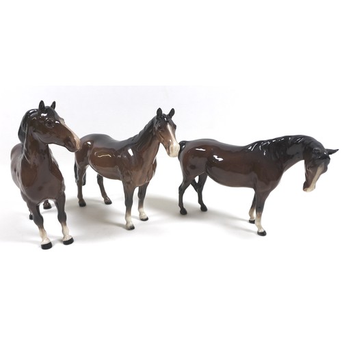 90 - A group of three Beswick horses, including 'Mare (Facing right, head down)', model 1812, brown - glo... 