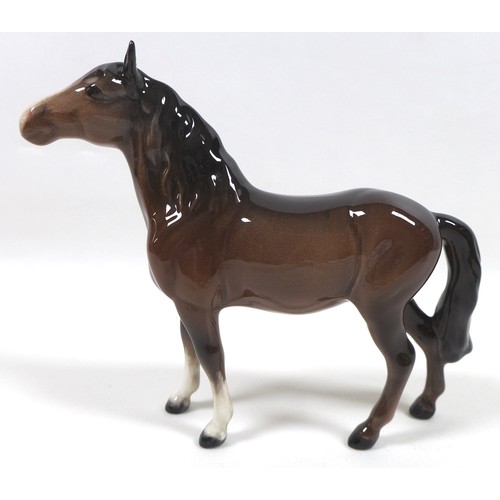 94 - A group of four Beswick horses, including two 'Pony (Head up)', model 1197, brown - gloss, 14cm high... 