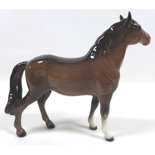 94 - A group of four Beswick horses, including two 'Pony (Head up)', model 1197, brown - gloss, 14cm high... 