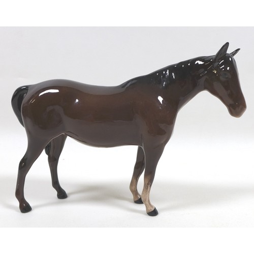 94 - A group of four Beswick horses, including two 'Pony (Head up)', model 1197, brown - gloss, 14cm high... 