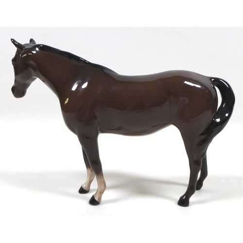 94 - A group of four Beswick horses, including two 'Pony (Head up)', model 1197, brown - gloss, 14cm high... 