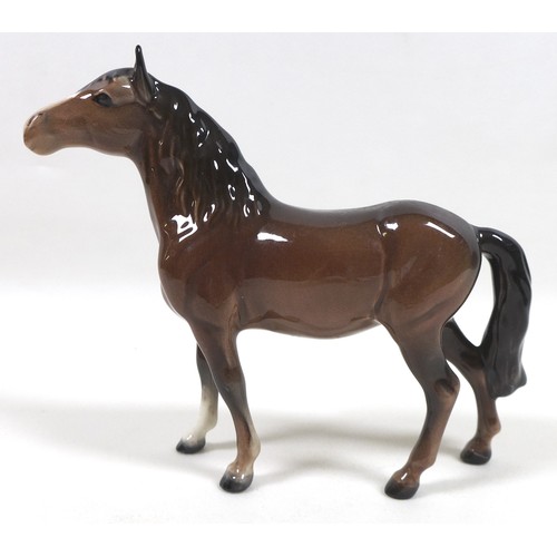 94 - A group of four Beswick horses, including two 'Pony (Head up)', model 1197, brown - gloss, 14cm high... 