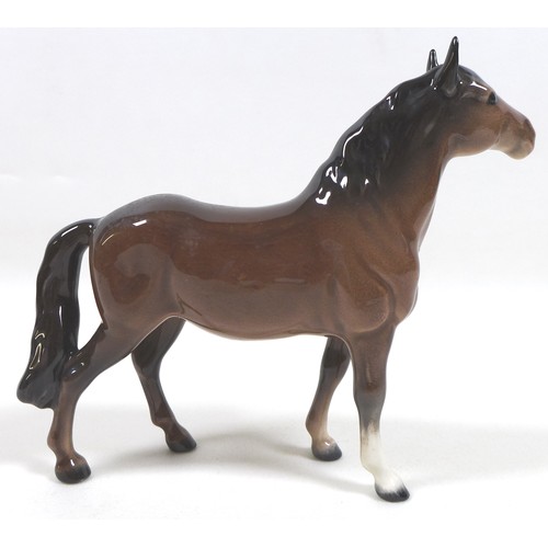 94 - A group of four Beswick horses, including two 'Pony (Head up)', model 1197, brown - gloss, 14cm high... 