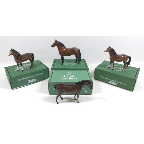 94 - A group of four Beswick horses, including two 'Pony (Head up)', model 1197, brown - gloss, 14cm high... 