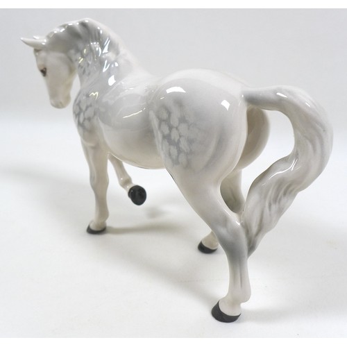 104 - A group of three Beswick horses, including 'Mare (Facing right, head down), model 1812. grey - gloss... 