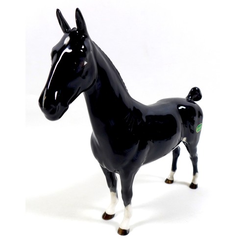 113 - A group of three Beswick horses, including 'Hackney - Black Magic of Nork', model 1361, black - glos... 