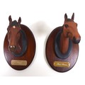 A pair of Beswick horse's head wall hangings, each mounted on oval shields with name plaques, modell... 