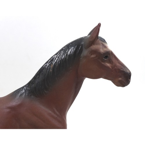 129 - A large Beswick horse, with short cropped tail and white rear left sock, bay - matt, 29cm high, stuc... 